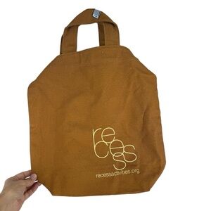 New Baggu duck bag. Golden mustard color with a logo for recess activities